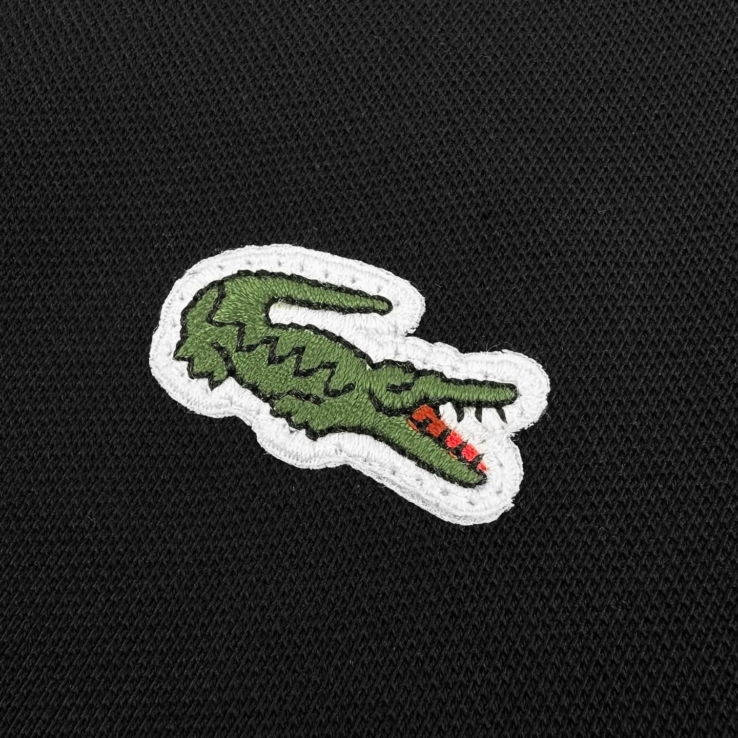 Lacoste crocodile logo Polo shirt (Black). The original version was purchased for 1,090. The fabric is made of custom-made glaze bee extract cotton. It is delicate, soft and comfortable. Breathable, soft black with a sense of breathing. Not heavy, not ostentatious. Use the calmest tones to interpret the French sense of relaxation. The iconic small crocodile jumps to the heart. On the pure black canvas, it outlines a low-key edge with a vivid attitude. Keep it simple. Use Black as the base and green crocodile as the print. It shows the texture and brand heritage in a low-key manner. It adopts the stamping process to make independent embroidered stamps through computer embroidery, and then positions them and sews them to fix it on the clothes. It has a strong three-dimensional effect, is strong and washable, has stable quality, and the fabrics have been washed with enzymes. It has a better hand feel and texture. It is not easy to deform, shrink or fade, and maintains long-term beauty. Size:S-M-L-XL